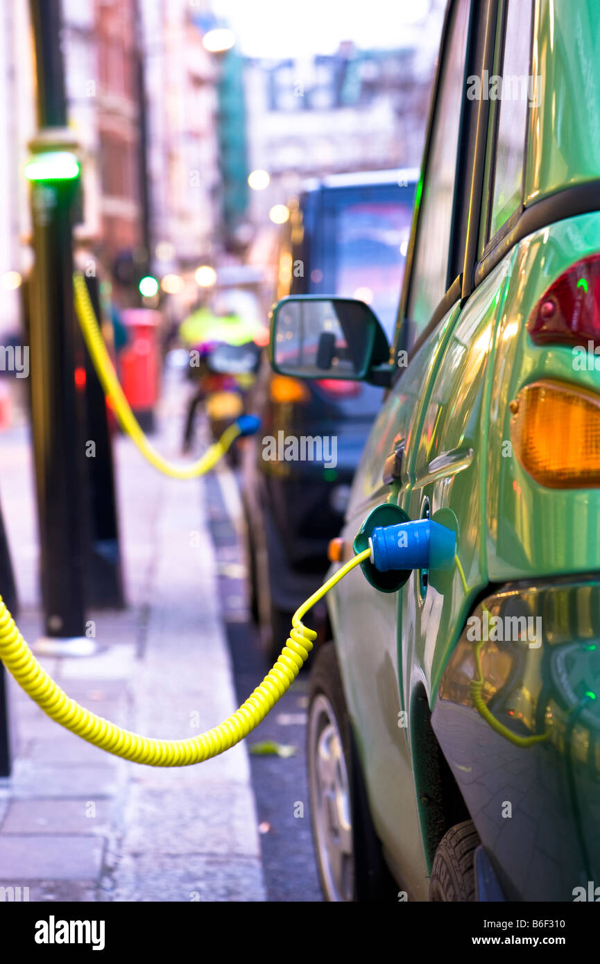 G Wiz electric car is being charged up from a City of Westminster Juice Point London United Kingdom Stock Photo