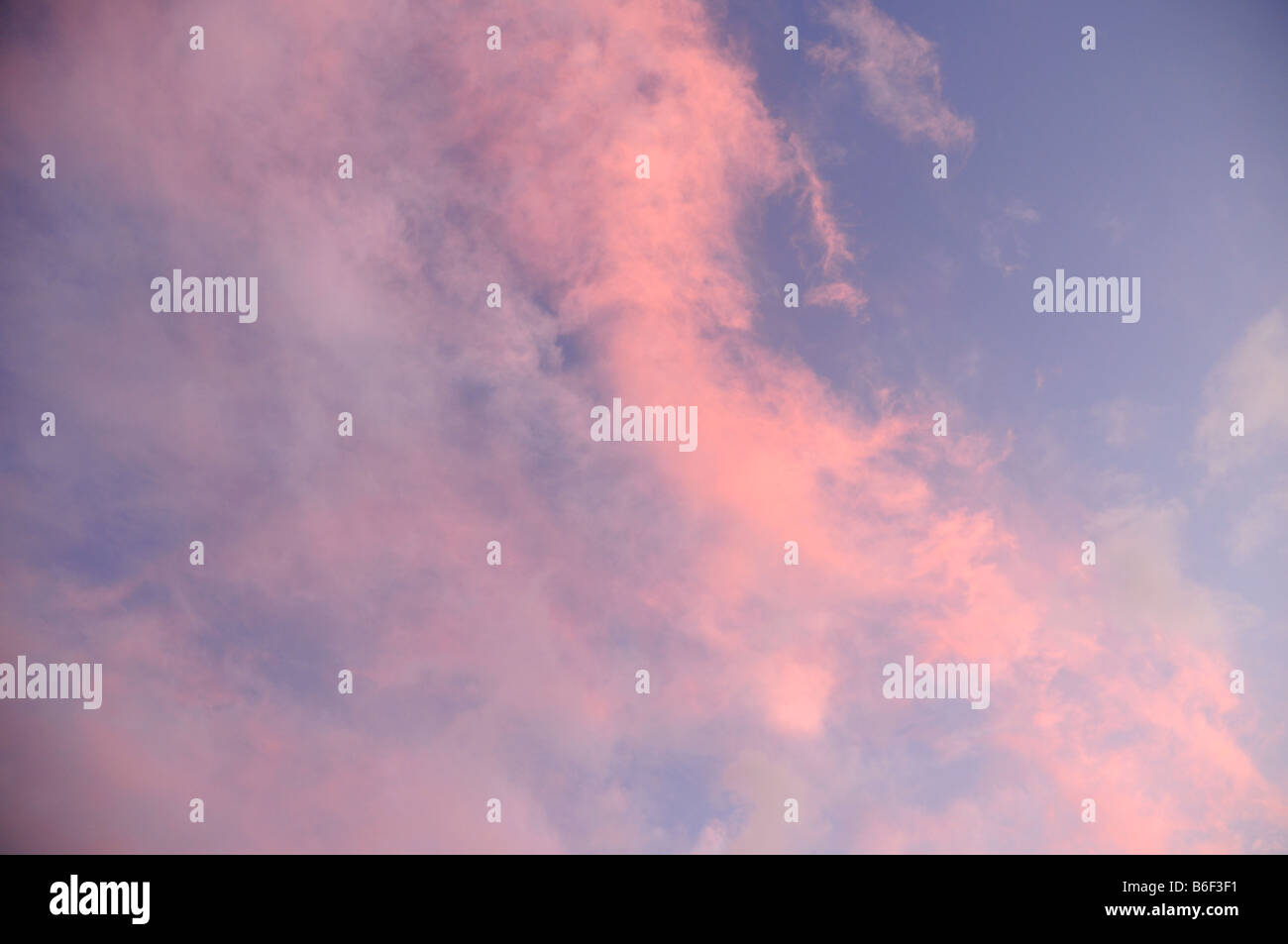 Blue sky with wispy pink  clouds Stock Photo