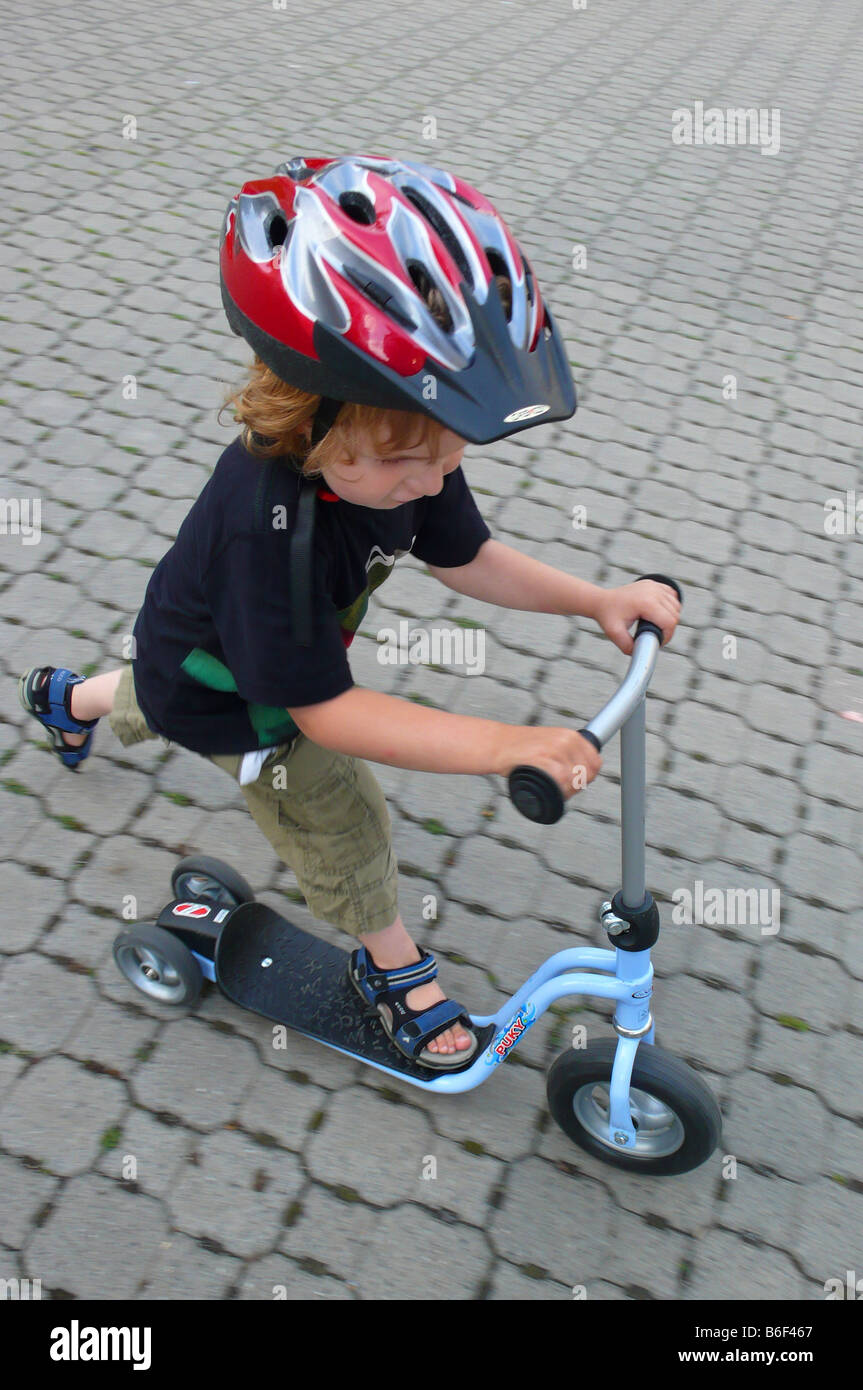 little boy with kickboard on a cobble street Stock Photo - Alamy