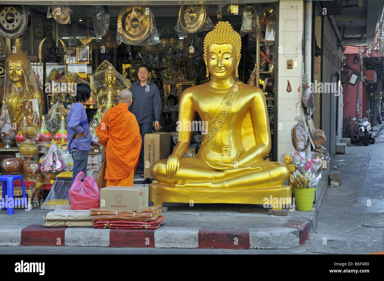 Buddha statue and devotional objects offering for sale in a store
