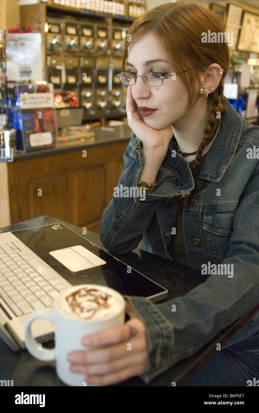 young woman with laptop, sitting in a cafe Stock Photo - Alamy