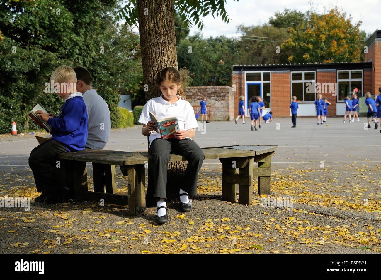 Schoolchildren Reading Books During Playtime In An English Primary ...