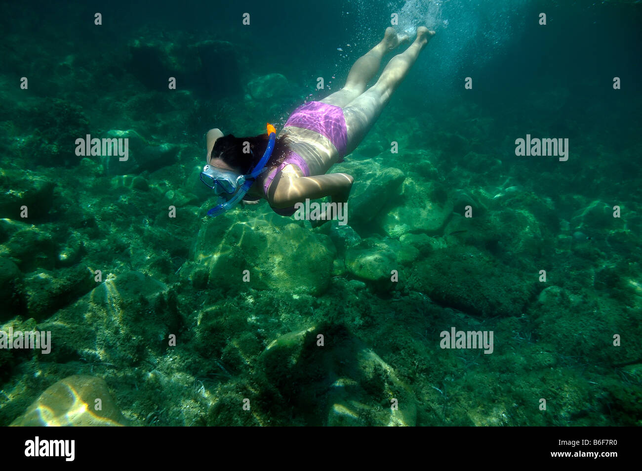 Woman with a snorkel and diving goggles scuba diving in the sea, underwater picture, Villasimius, Sardinia, Italy, Europe Stock Photo