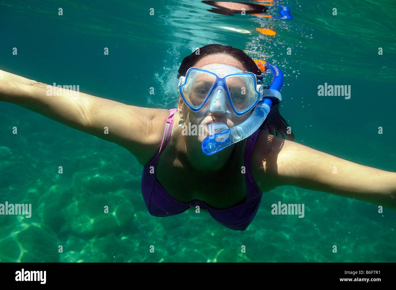 Woman with a snorkel and diving goggles scuba diving in the sea, underwater picture, Villasimius, Sardinia, Italy, Europe Stock Photo