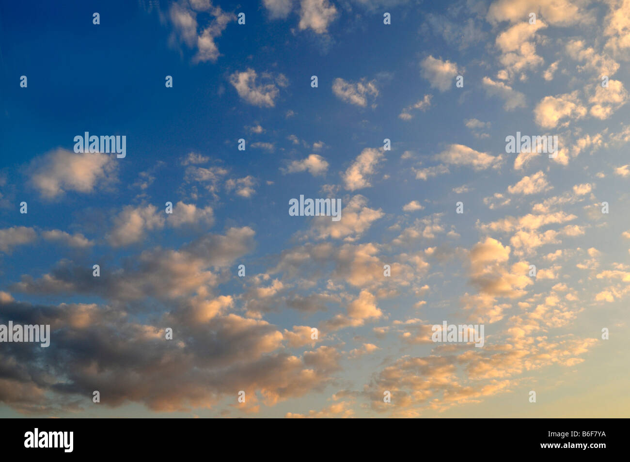 Fair-weather clouds in a blue sky at sunset Stock Photo