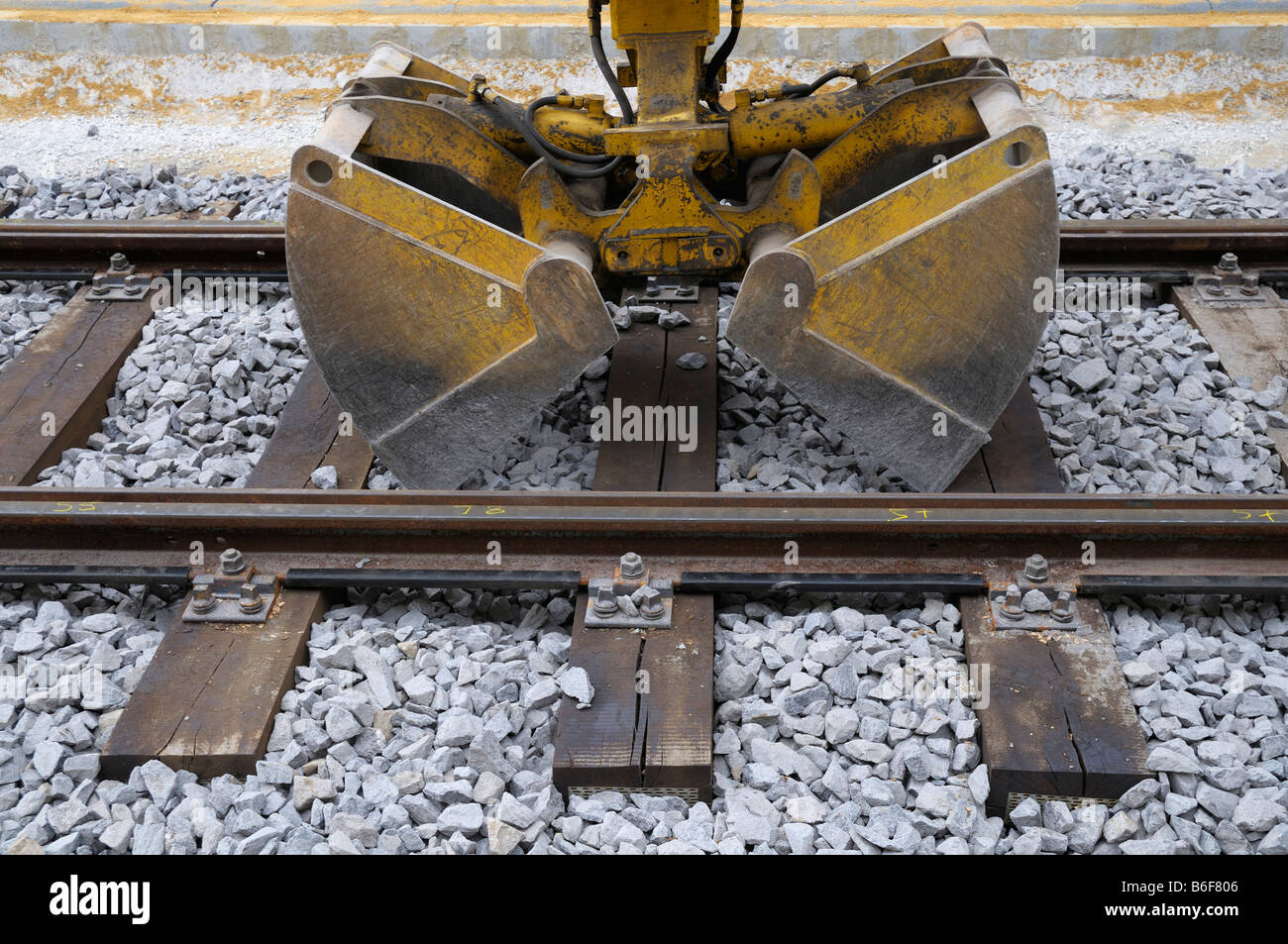 Track construction work, excavator shovel in track bed Stock Photo Alamy