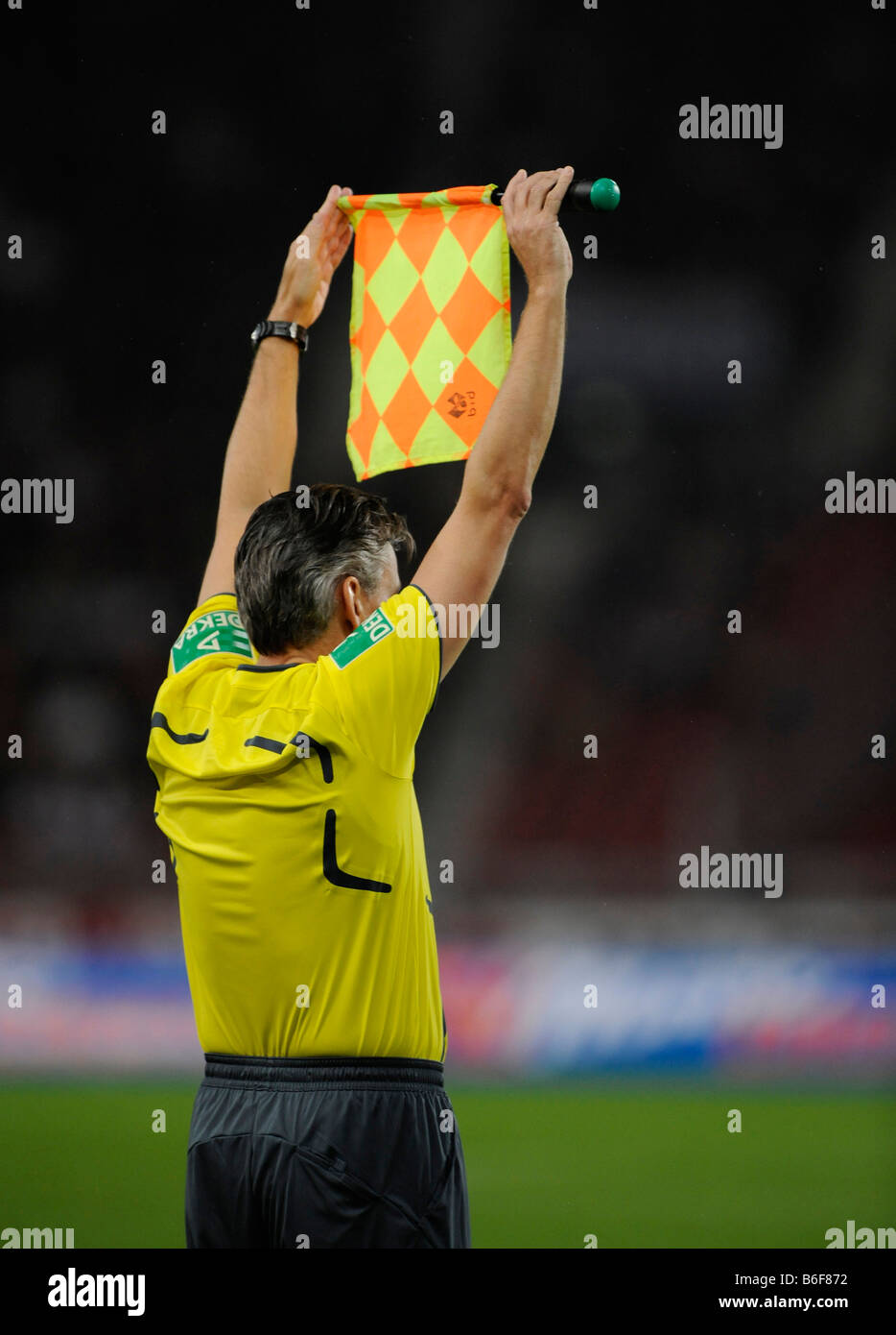 Linesman showing his flag, interruption of the game for substitution of players Stock Photo