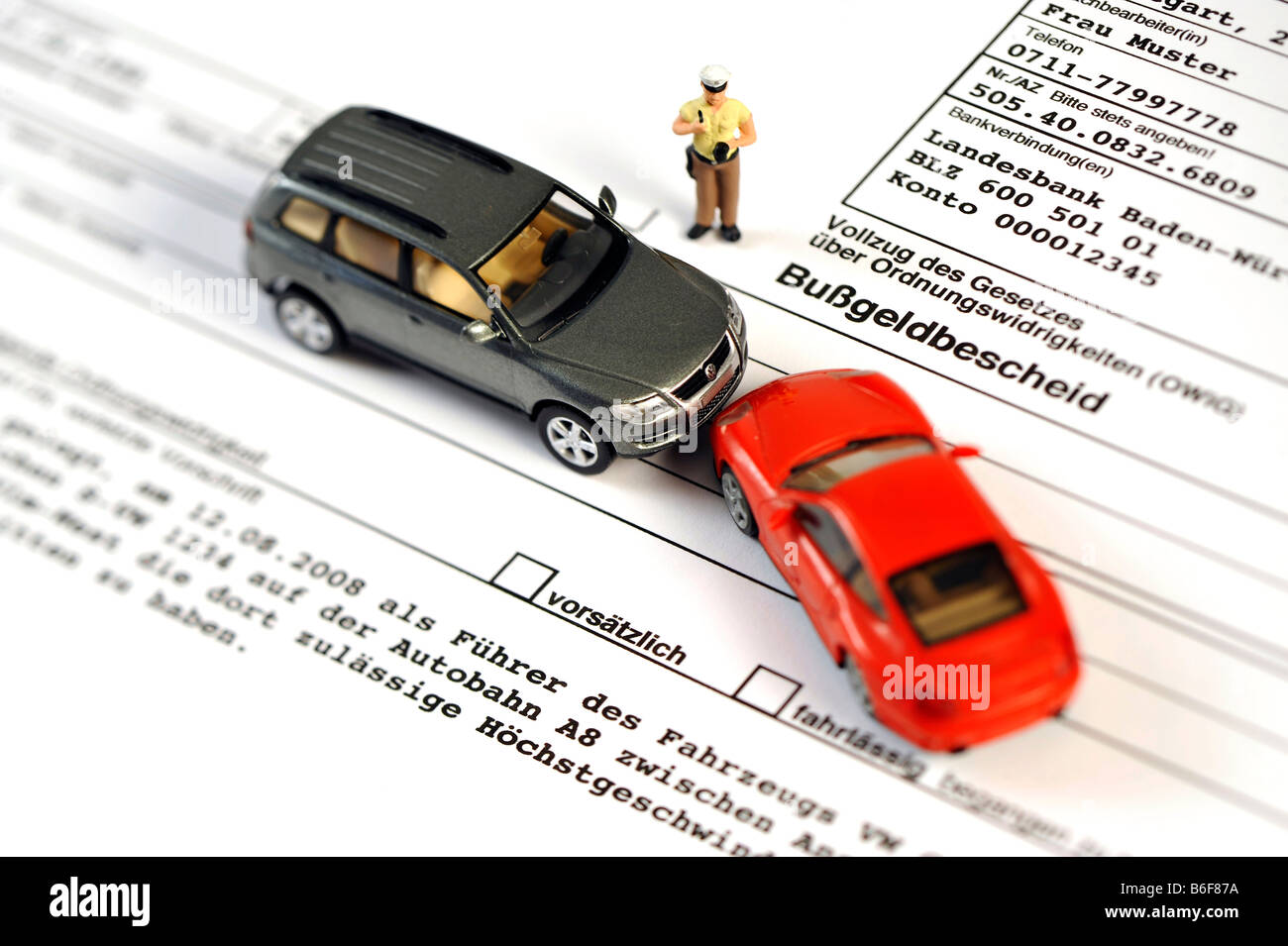 Policeman, VW Touareg and Porsche 911 cars, as miniature figures on a traffic violation ticket Stock Photo
