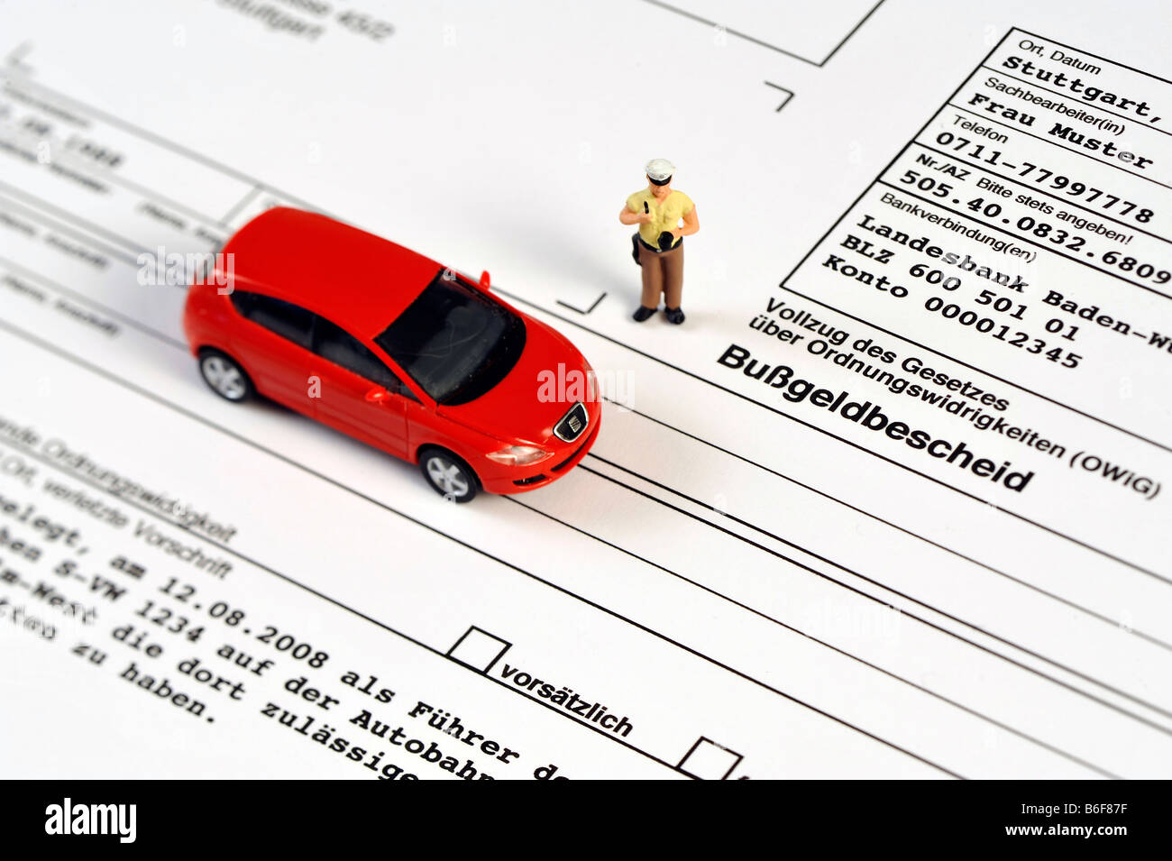 Policeman and Peugeot car as miniature figures on a traffic violation ticket Stock Photo