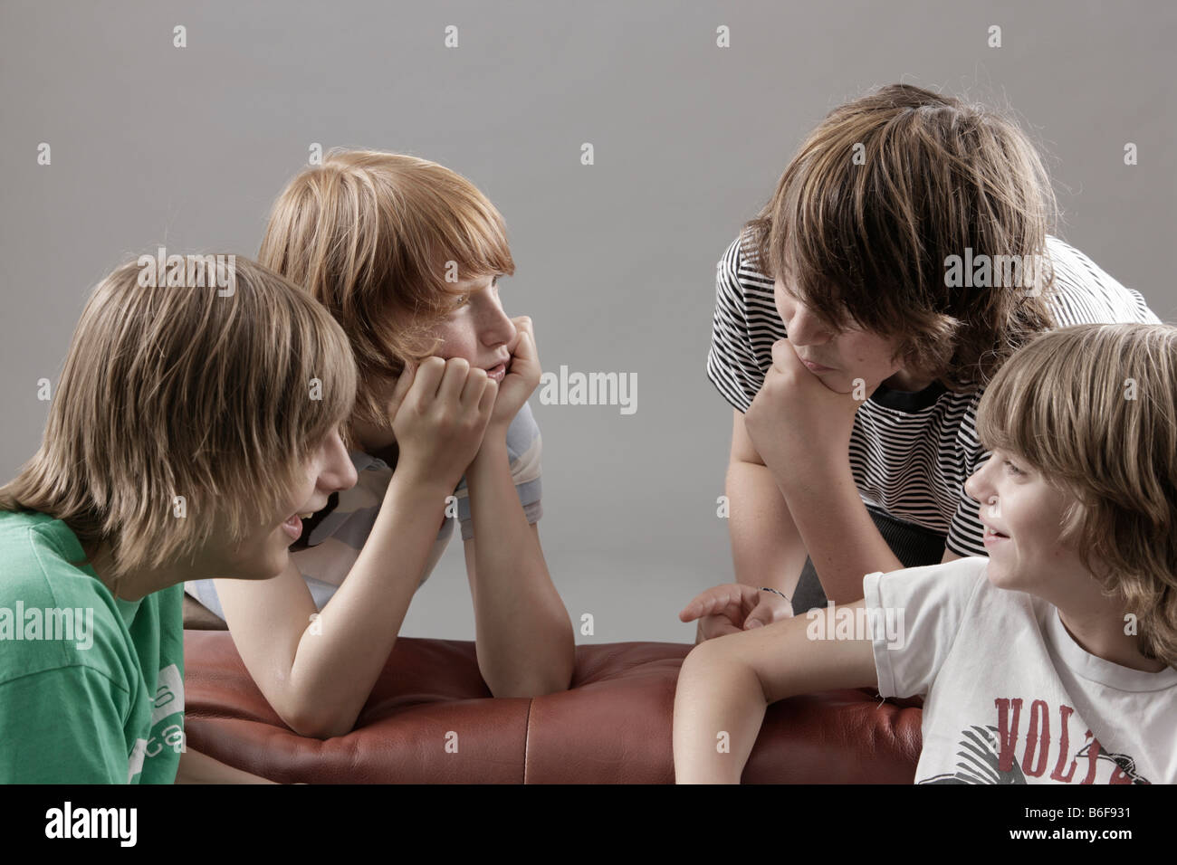 Four boys talking amongst themselves Stock Photo Alamy