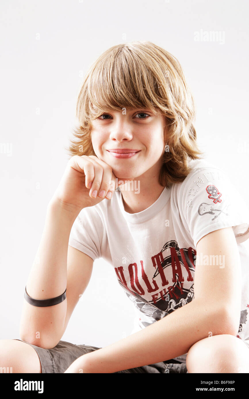 12 year-old boy looking into the camera, smiling Stock Photo