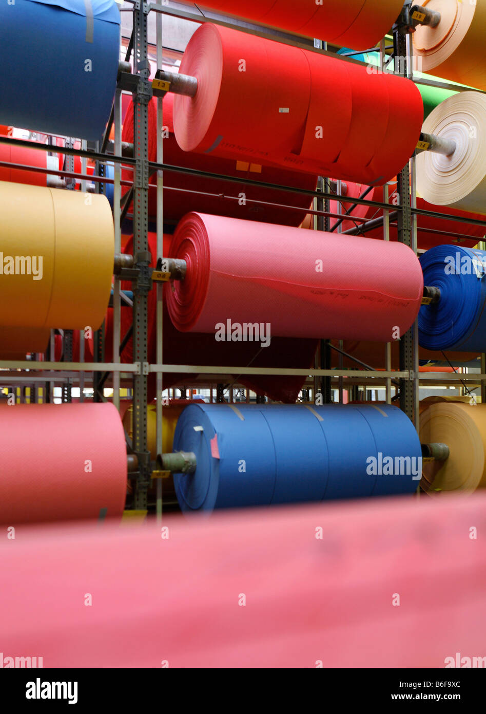Store filled with rolls of nonwoven fabric in all colors for the production of commercial cleaning cloths used by cleaning serv Stock Photo