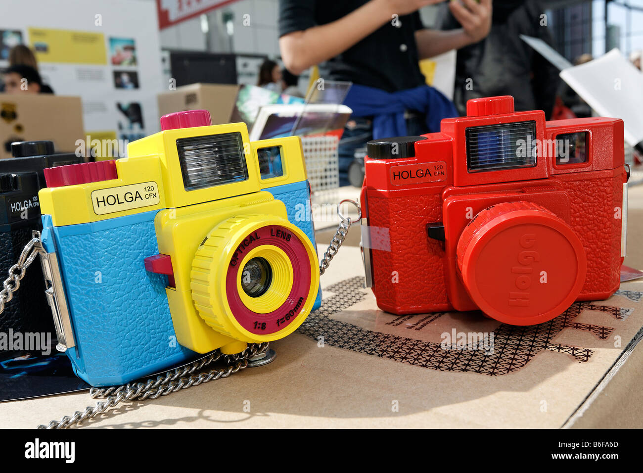 Two cheap cameras manufactured by Holga, a Chinese firm, made out of colored plastic, lomography exhibition stand at the Photok Stock Photo