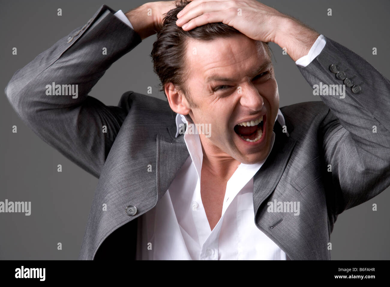 Man tears at or ruffles his hear Stock Photo - Alamy