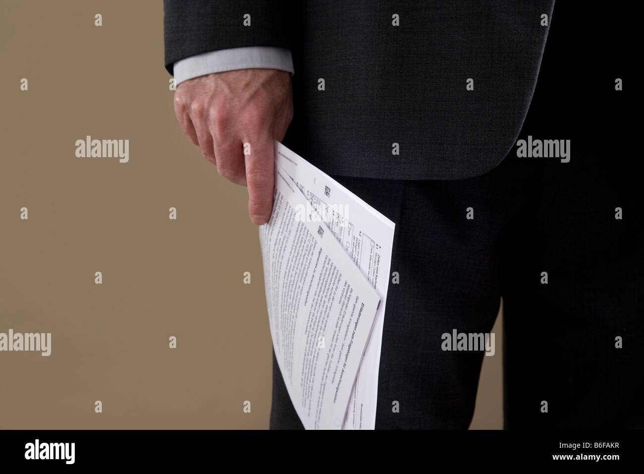 Hand of a businessman with papers Stock Photo