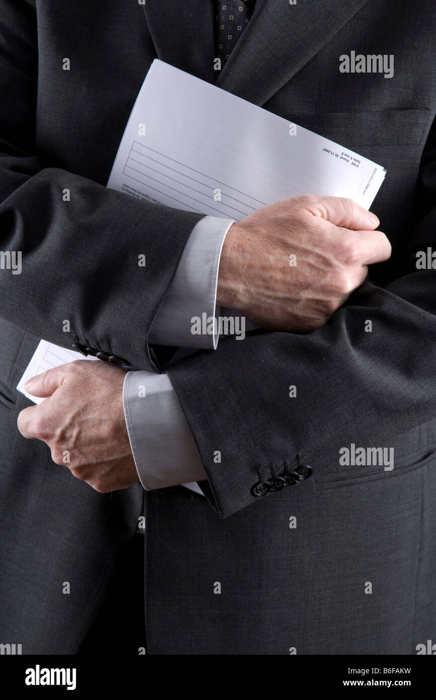 Arms of a businessman with papers Stock Photo