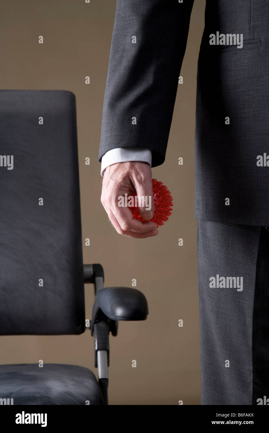 Hand of a businessman with a fitness ball Stock Photo