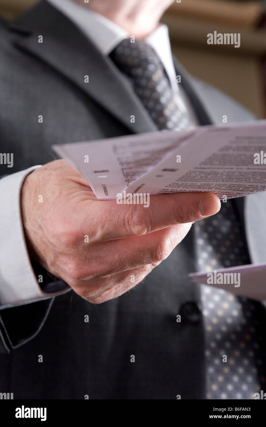 Hand of a businessman with papers Stock Photo