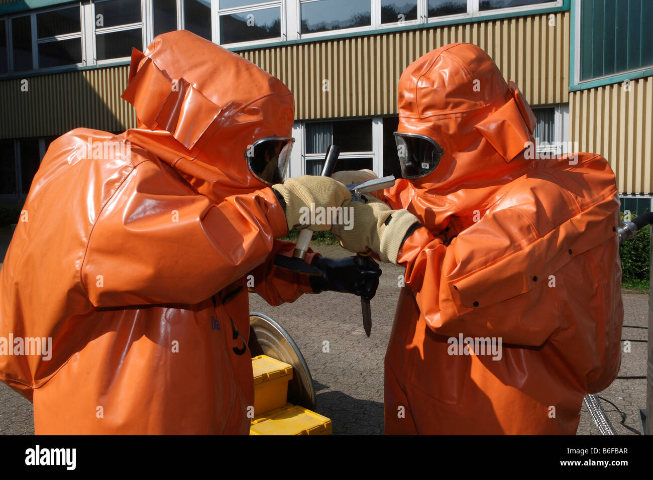 Hazardous material practice of the fire brigade wearing protective clothing Stock Photo