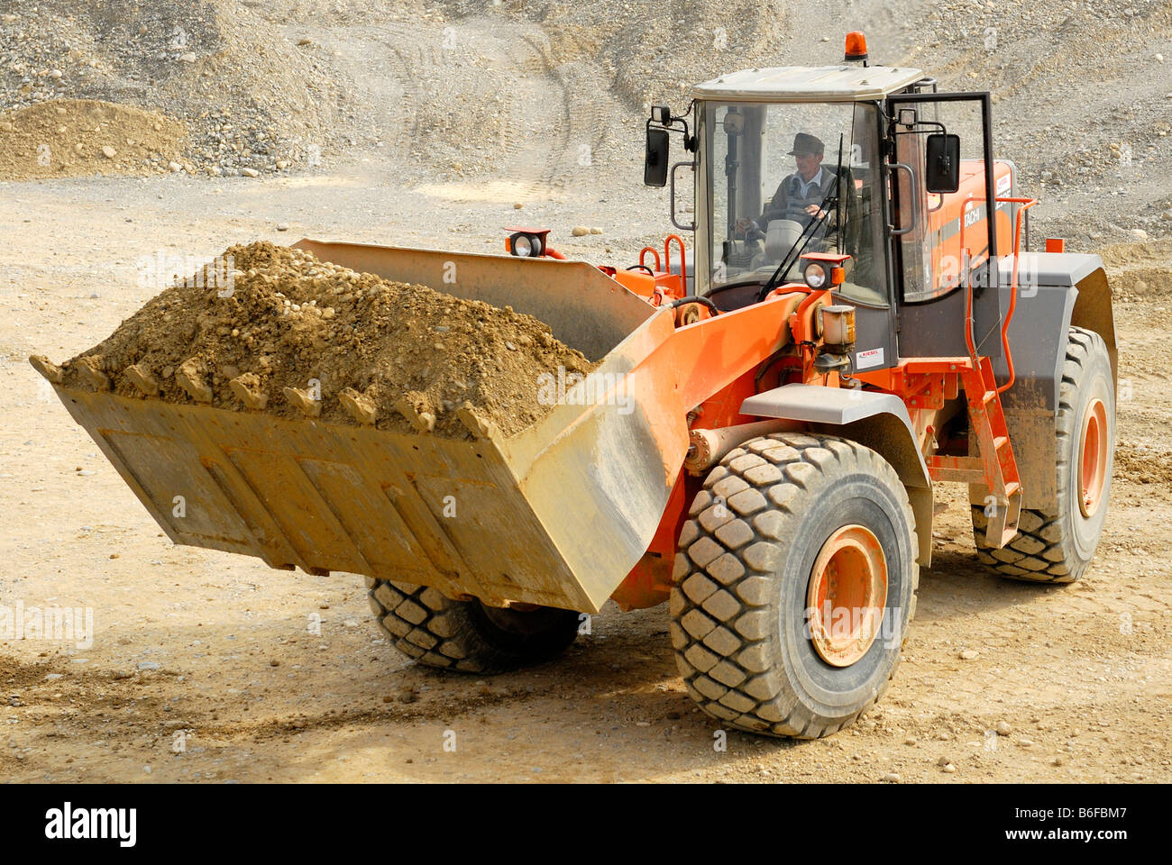Hitachi LX 290E wheeled loader carrying gravel in a gravel pit Stock Photo