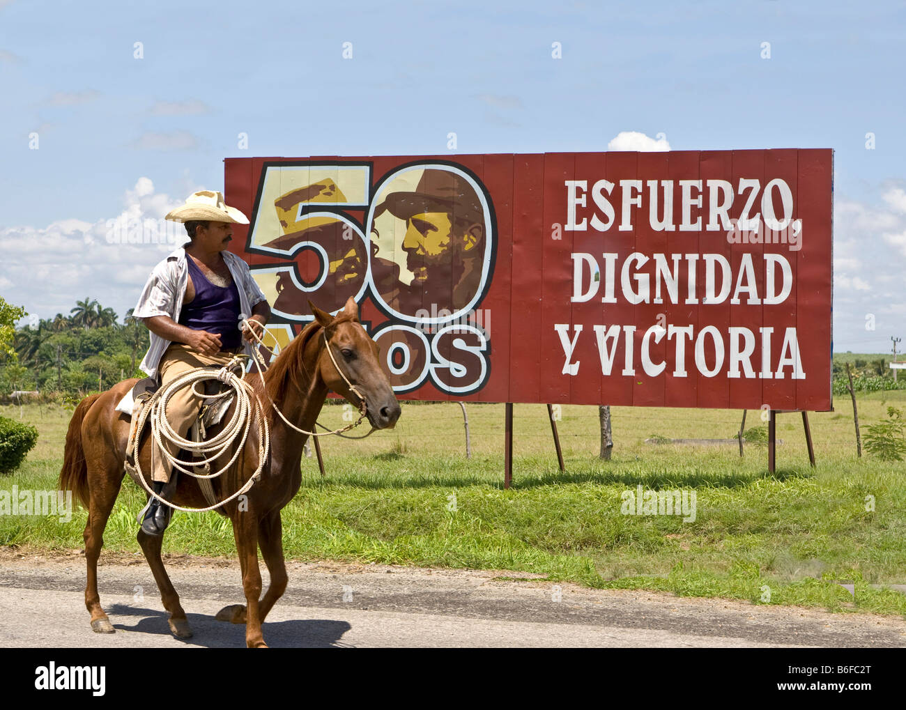 Cuban rider in front of a Fidel Castro sign, Cuba, Latin America Stock Photo