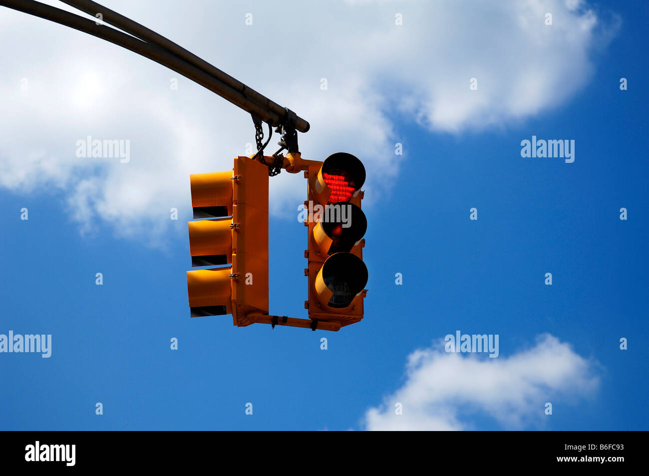 Yellow traffic light in front of blue sky in Newton, New Jersey, USA Stock Photo