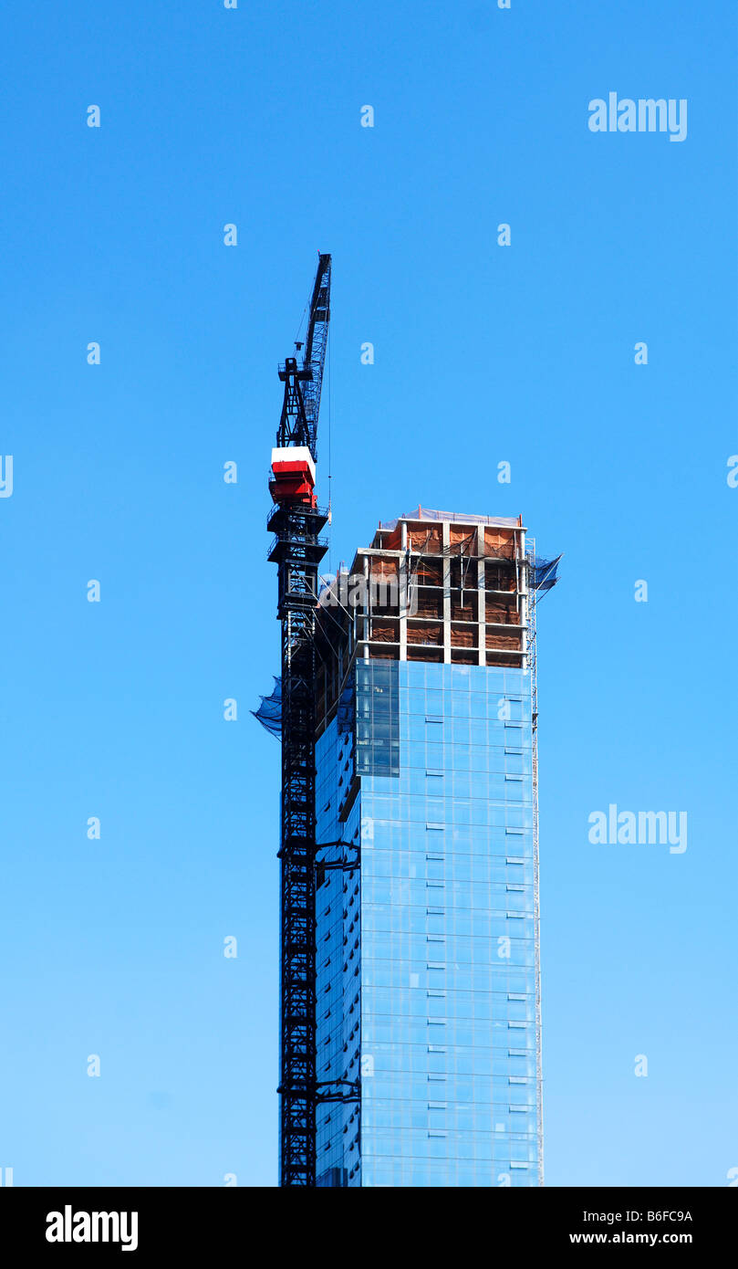 Skyscraper being built, rising into blue sky, New York City, NY, USA