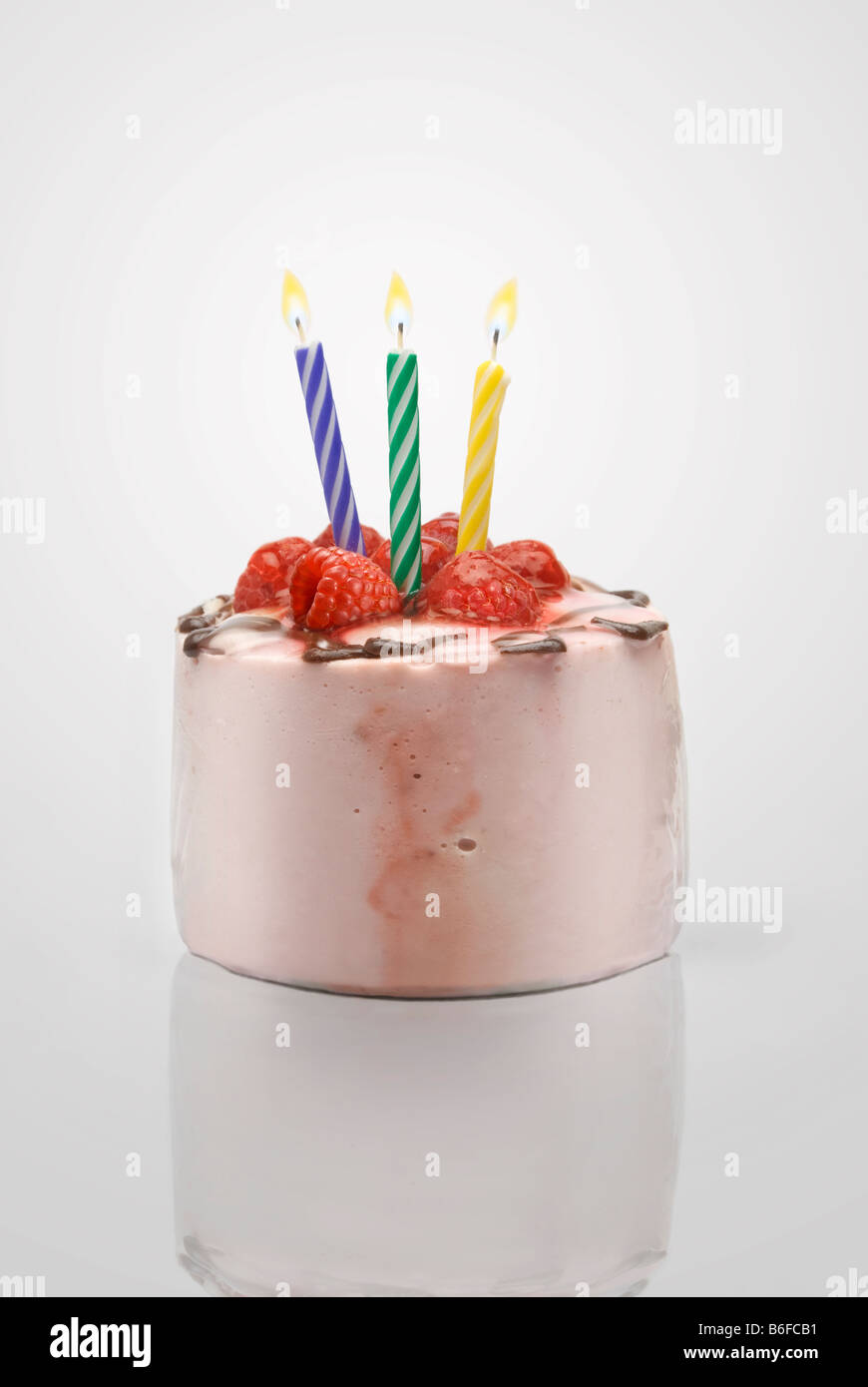 birthday cake with three lighted candles over a blank background Stock ...