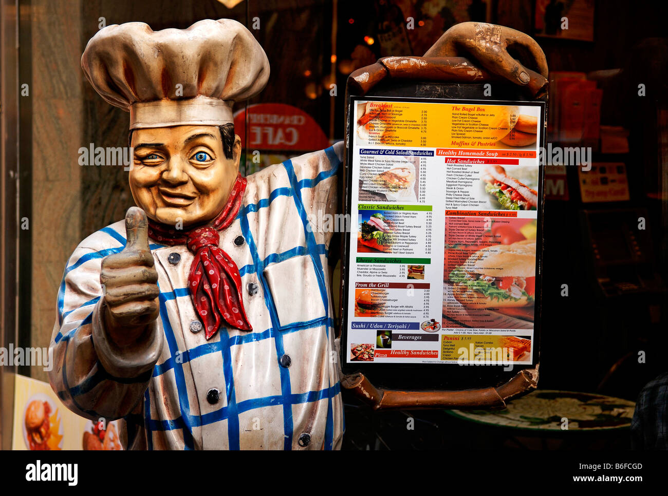 Chef holding a menu, figure in front of a restaurant in New York City, NY, USA Stock Photo