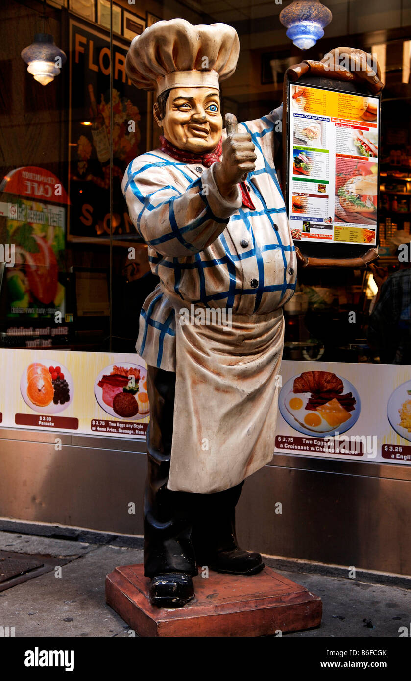 Chef holding a menu, figure in front of a restaurant in New York City, NY, USA Stock Photo