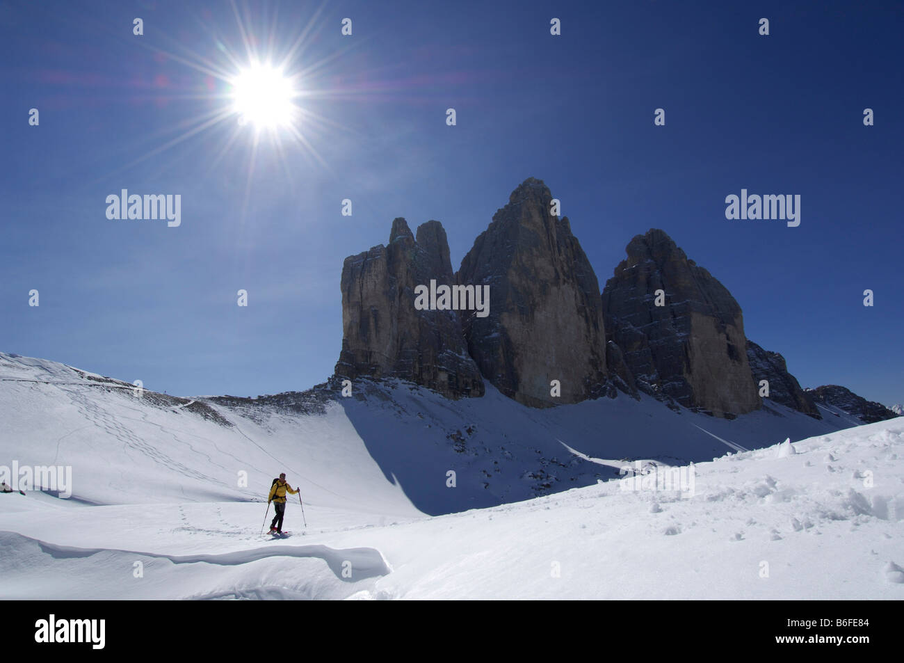 Snowshoe hiker passing the Drei Zinnen Mountain or Tre Cime di Lavaredo, High Puster Valley or Alto Pusteria, Bolzano-Bozen, Do Stock Photo