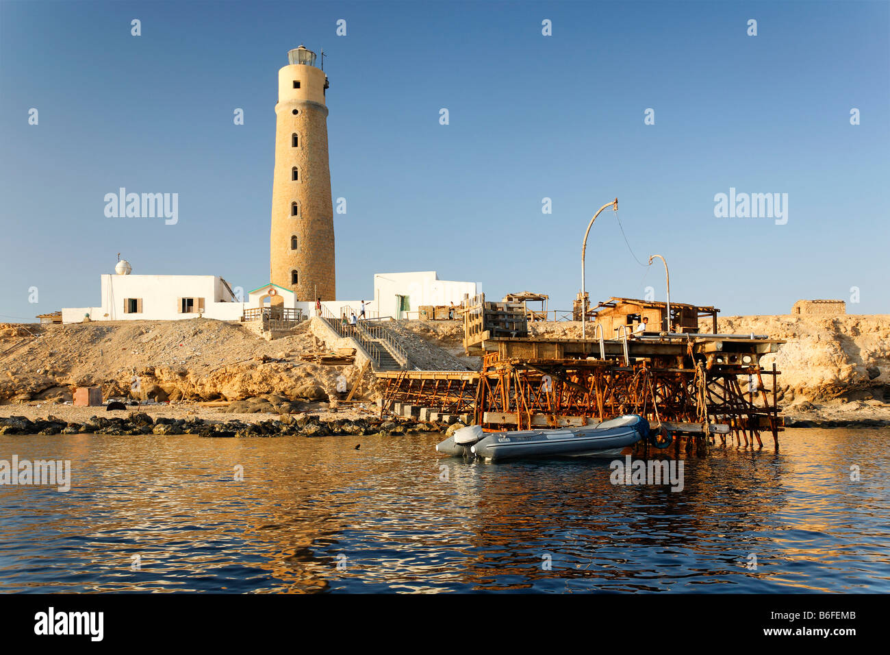 Lighthouse and pier on island with no vegetation, top scuba diving location, The Brother Islands or El Akhawein in Arabic, Egyp Stock Photo