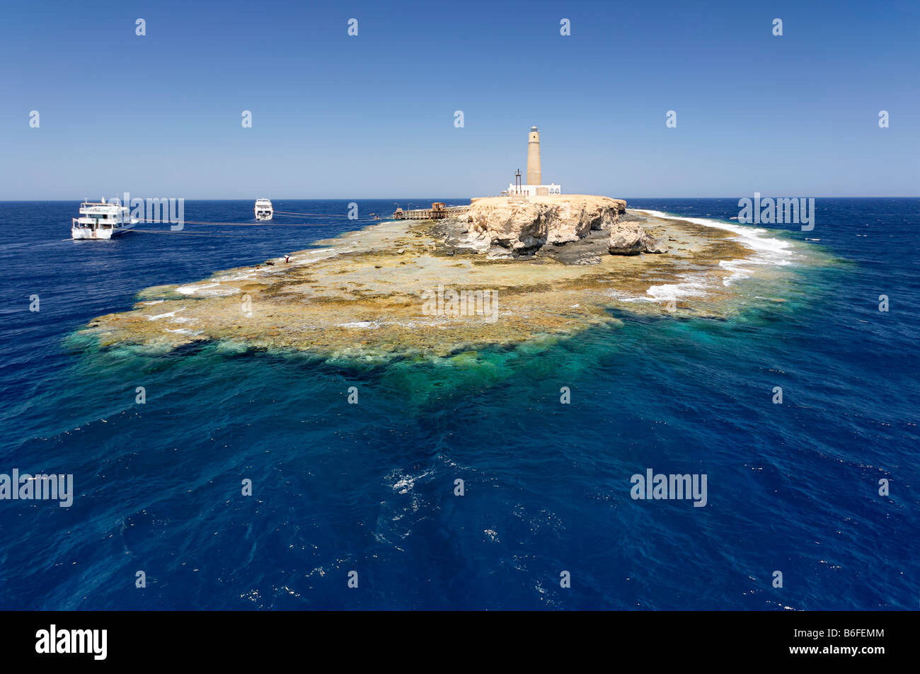 Small island and reef in ocean, lighthouse and dive boats, top scuba diving location, Big Brother of The Brothers Islands or El Stock Photo