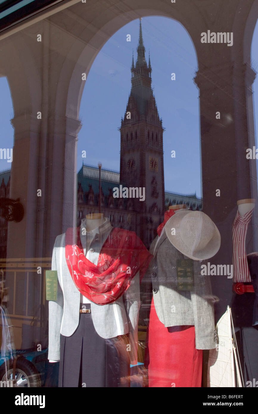 Fashion store in the arcades with woman's clothing and a reflection of the City Hall tower, Hamburg, Germany, Europe Stock Photo