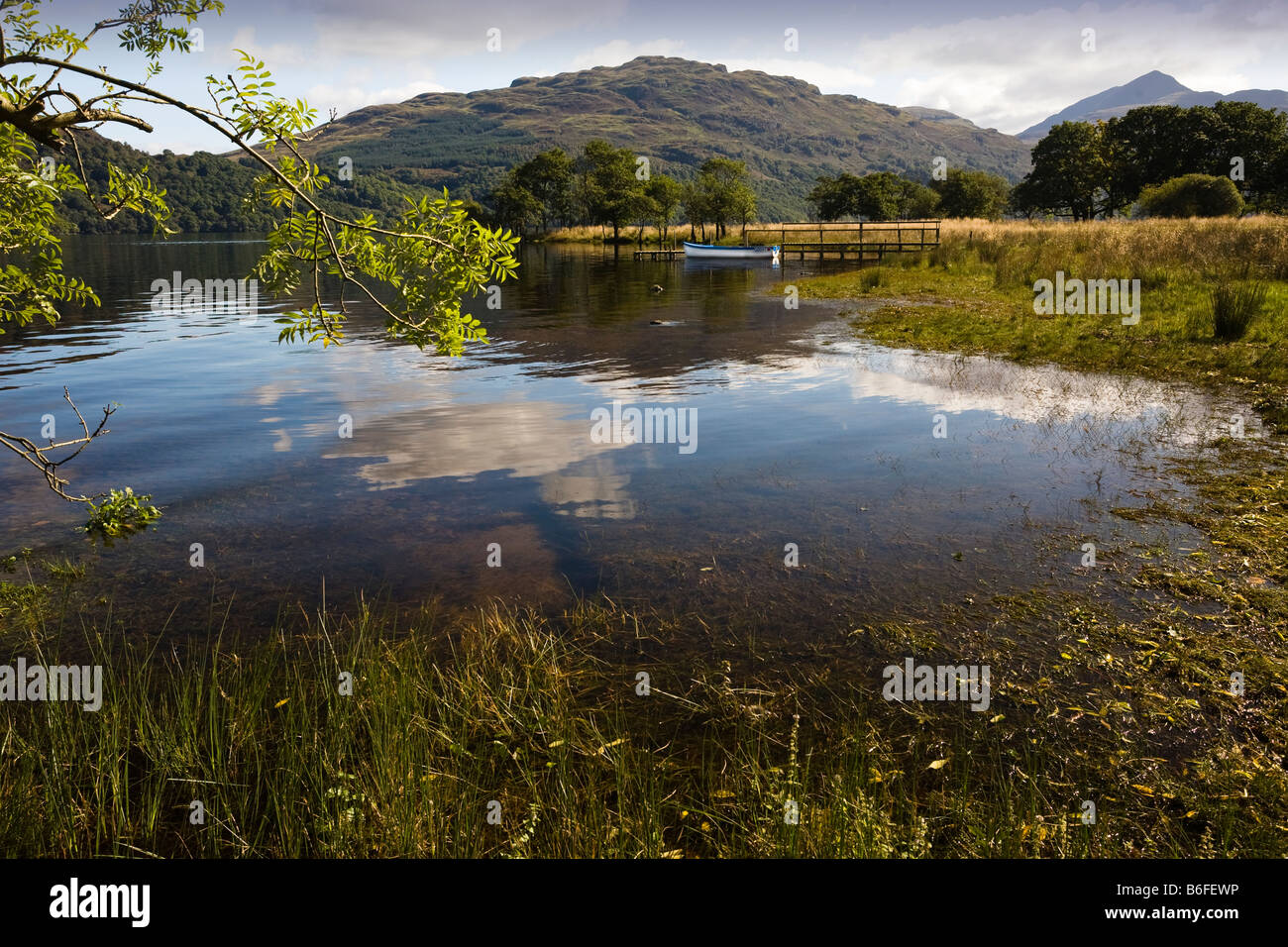 Boat on Loch Lomond Scotland with Ben Lomond in the background top right Stock Photo