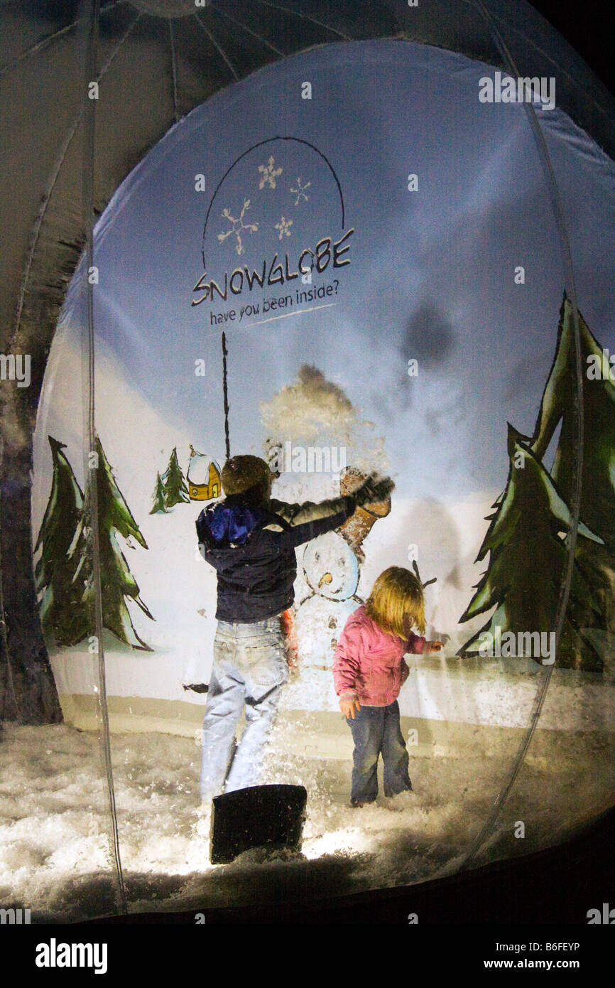 UK Cheshire Chester Zoo Frost Fair children playing in artificial snow globe Stock Photo