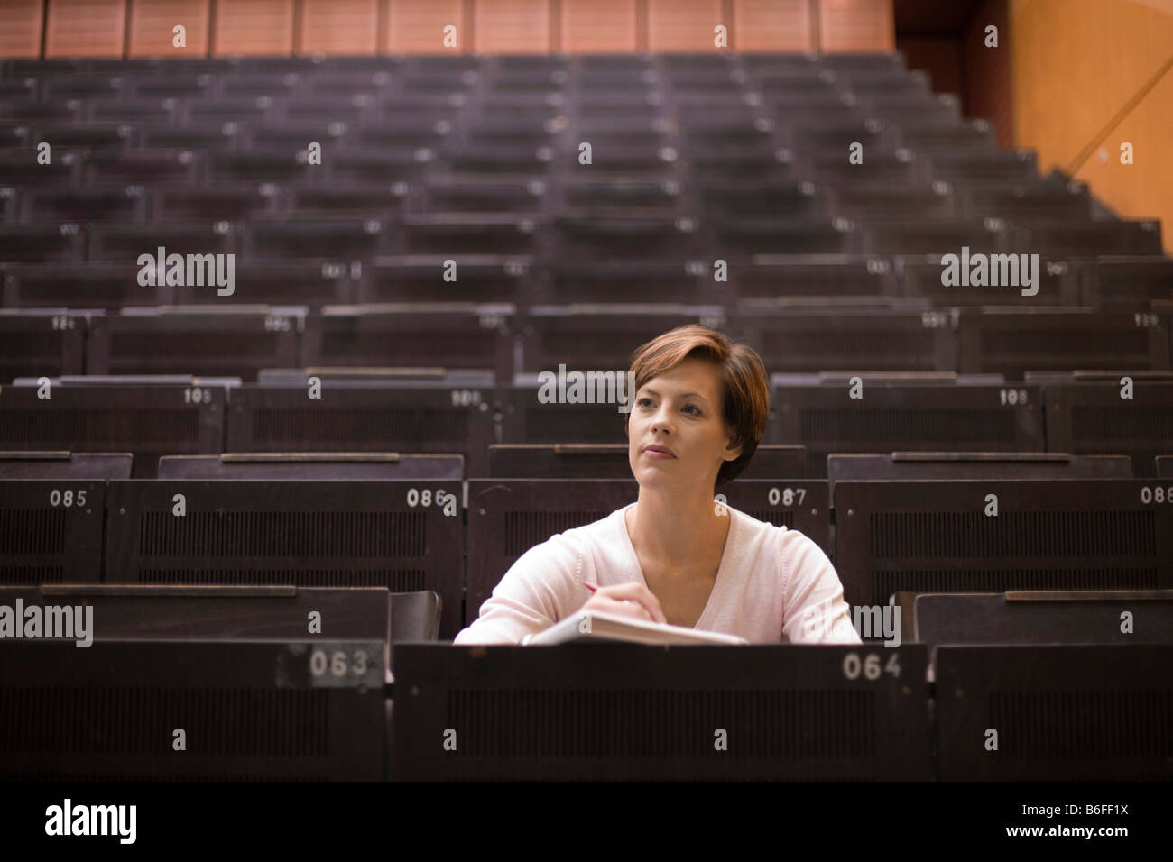 Female student in the lecture hall Stock Photo