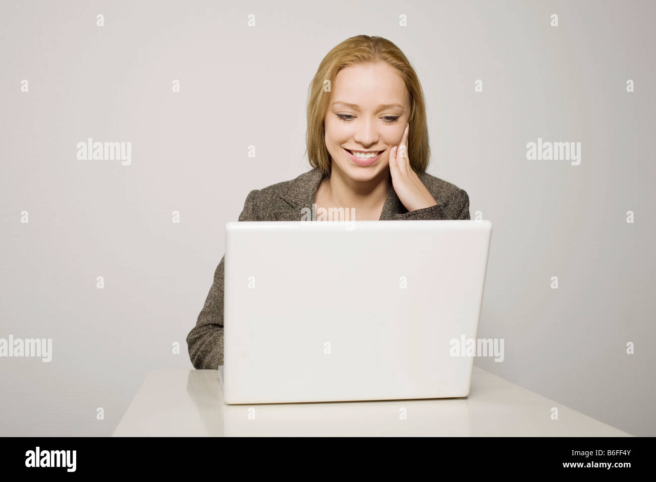 Young long-haired woman working on a notebook Stock Photo