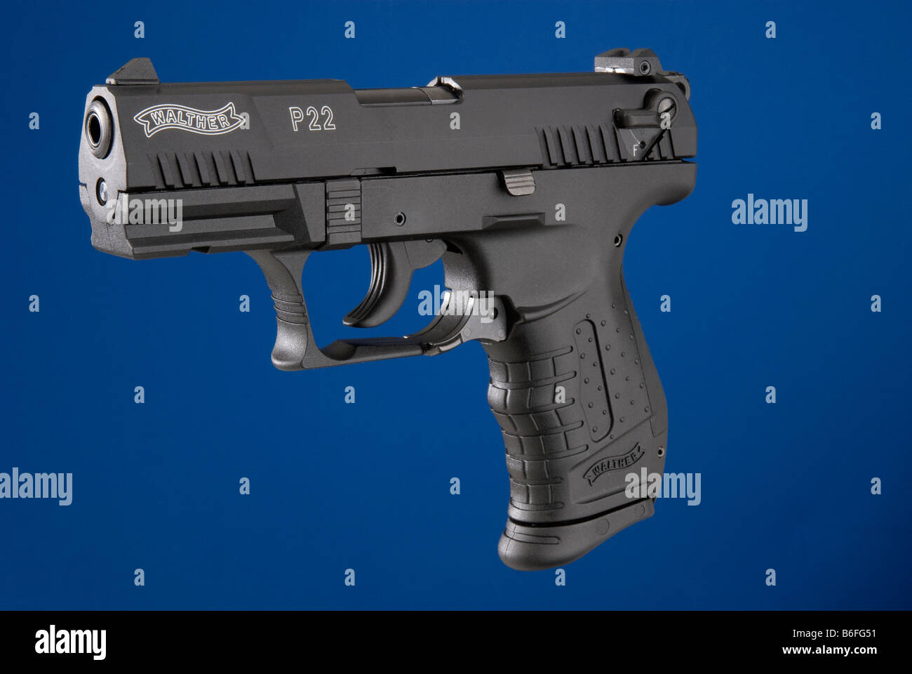 Walther P22 semi automatic .22 cal handgun on keyable blue background Stock Photo