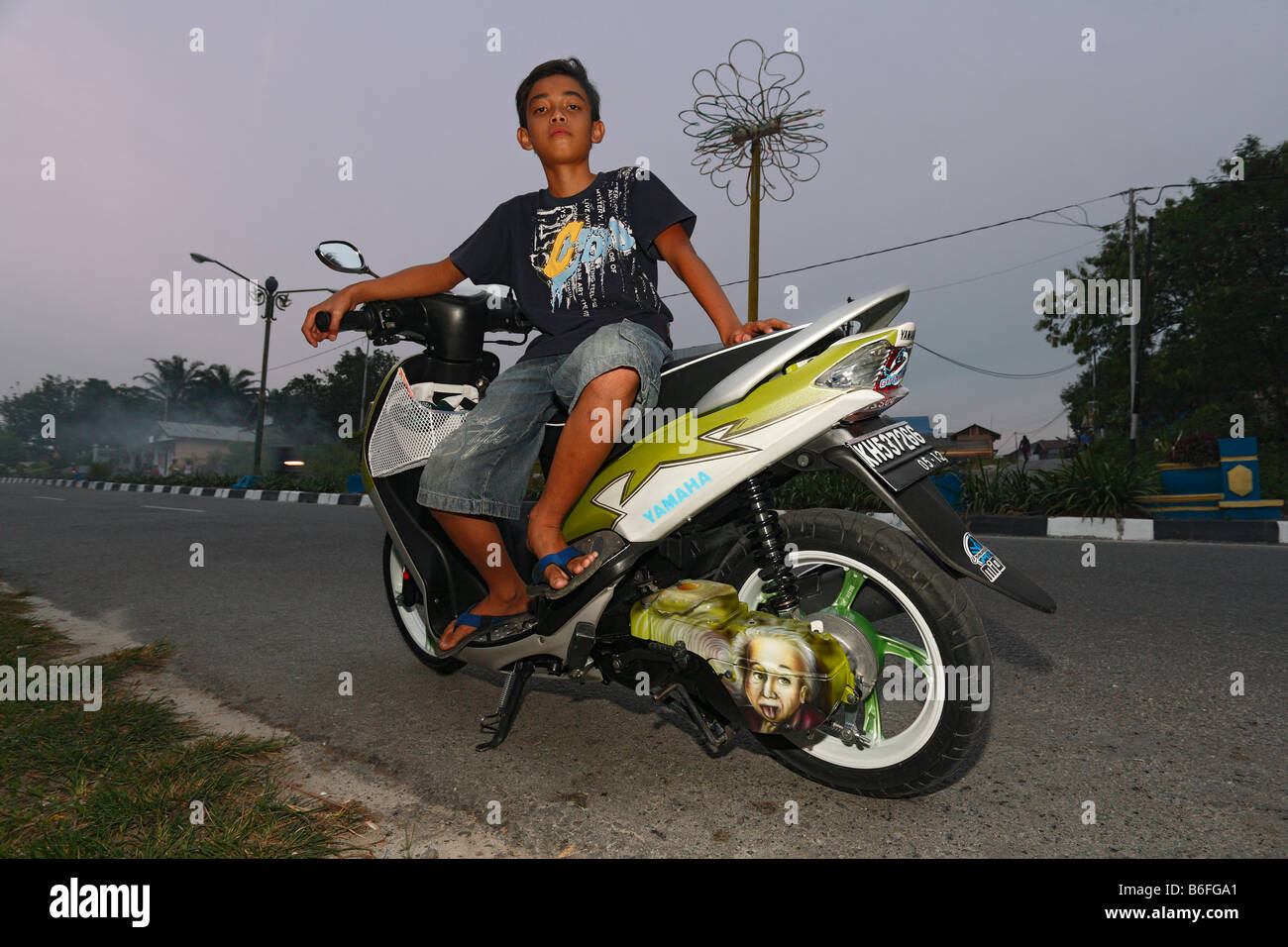 Boy on a scooter, Pangkalanbun, Central Kalimantan, Borneo, Indonesia, Southeast Asia Stock Photo