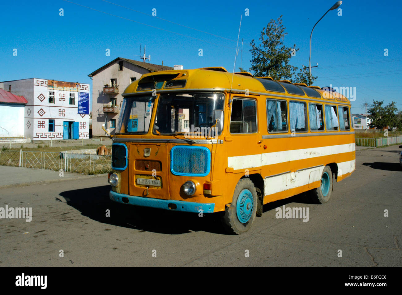 Old, yellow, Russian bus in Ulaangom, Uvs Aimag, Mongolia, Asia Stock Photo