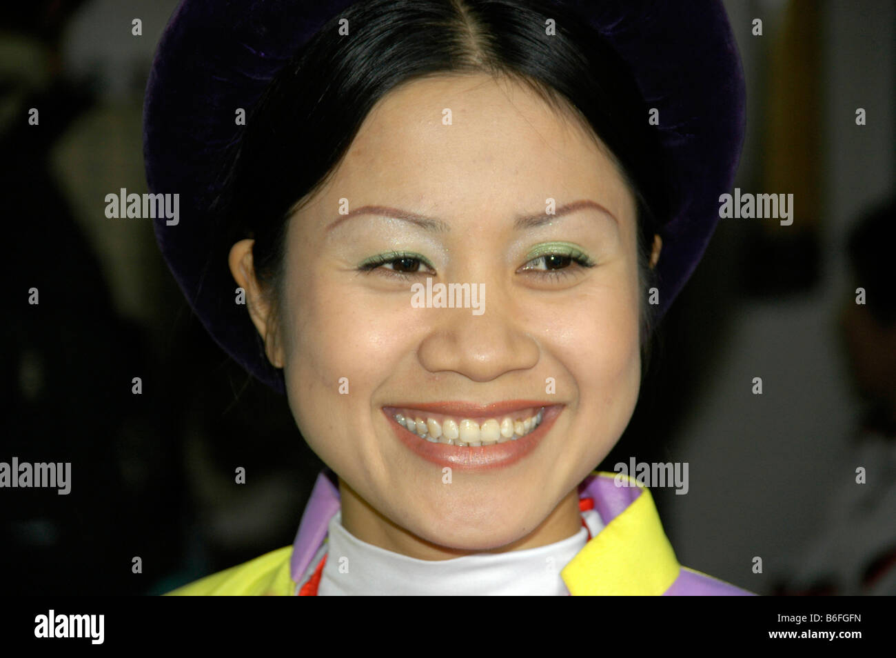 Portrait of a smiling young woman in traditional dress, Hanoi, Vietnam, Southeast Asia Stock Photo