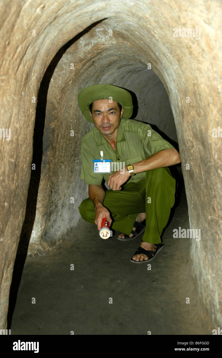 Man crouching in a low aisle of a cave, Cu Chi, Vietnam, Southeast Asia Stock Photo