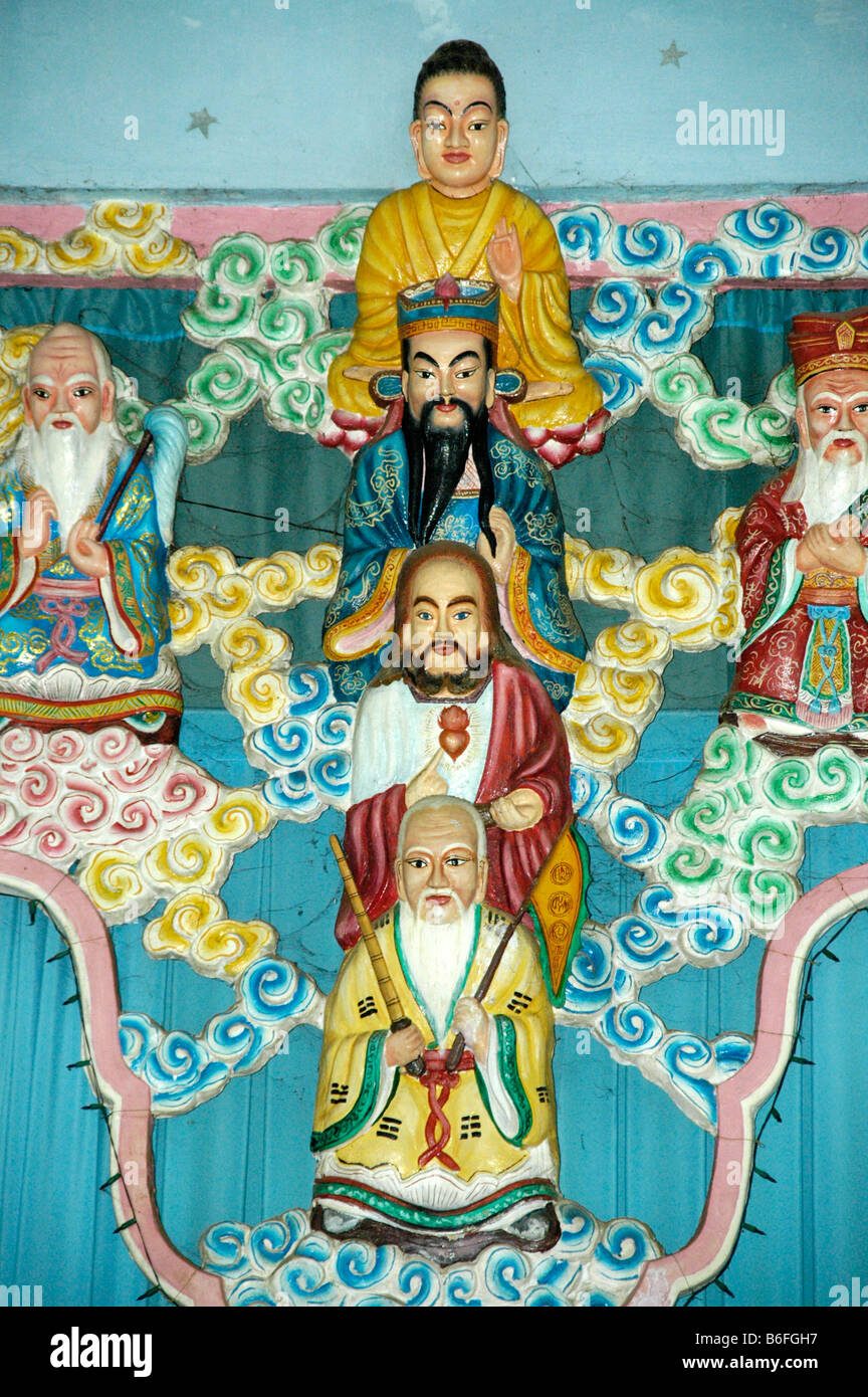 Colourful figures of Buddha, Mohammed and Jesus Christ in the Cao Dai Temple in Go Dao near the city of Ho Chi Minh, Saigon, Vi Stock Photo