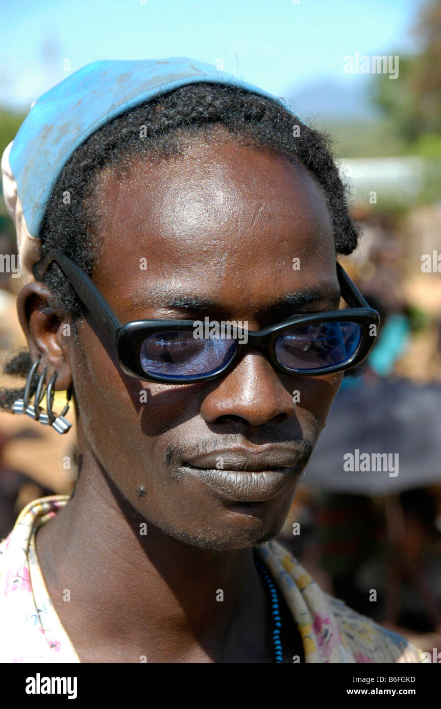 Man wearing black horn-rimmed glasses, portrait, at the markets in Dimeka, Ethiopia, Africa Stock Photo