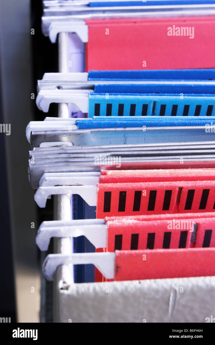 Heap of coloured files in sliding filing cabinet Stock Photo