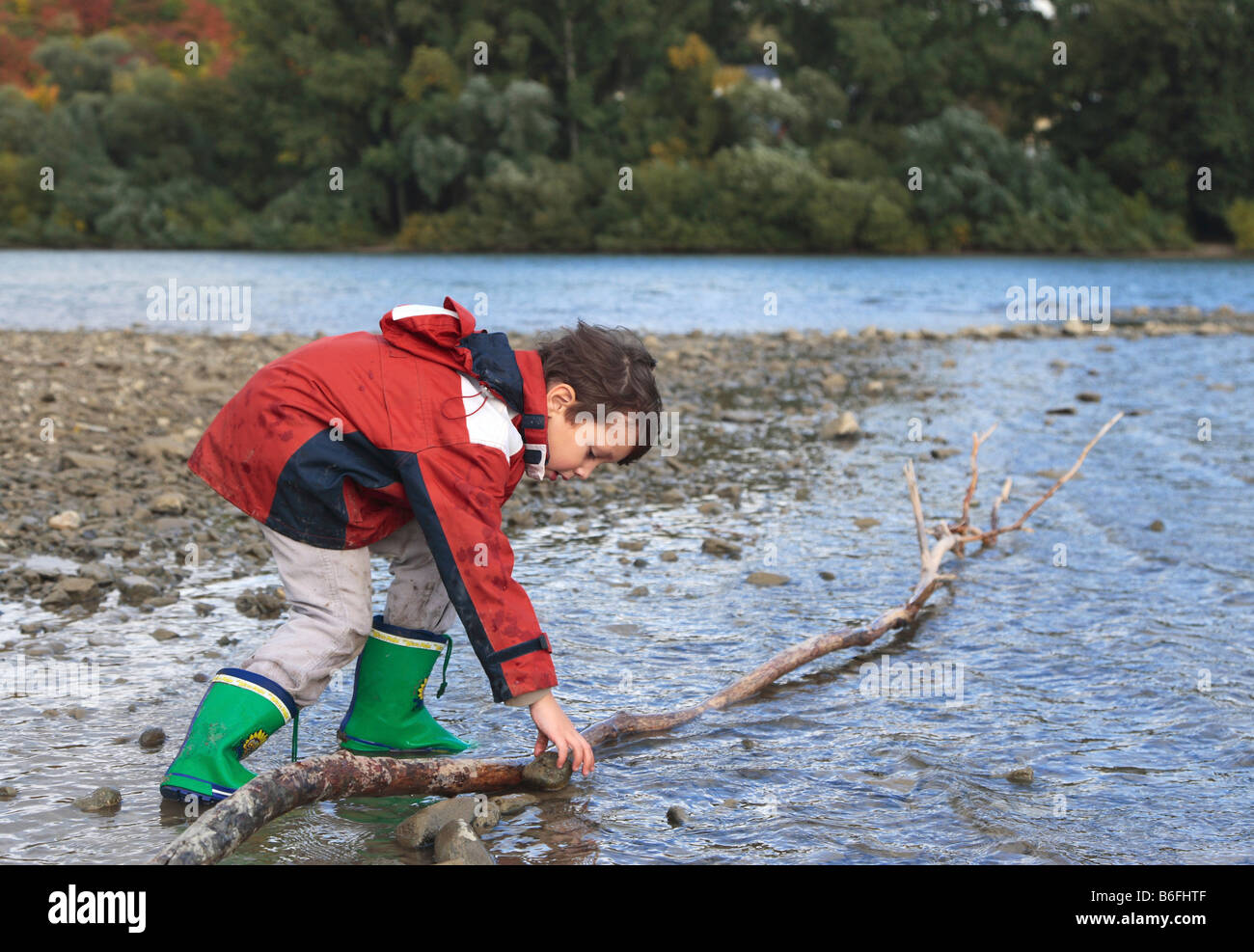 Child playing on the banks of the Rhine River, Niederwerth, Rhineland-Palatinate, Germany, Europe Stock Photo