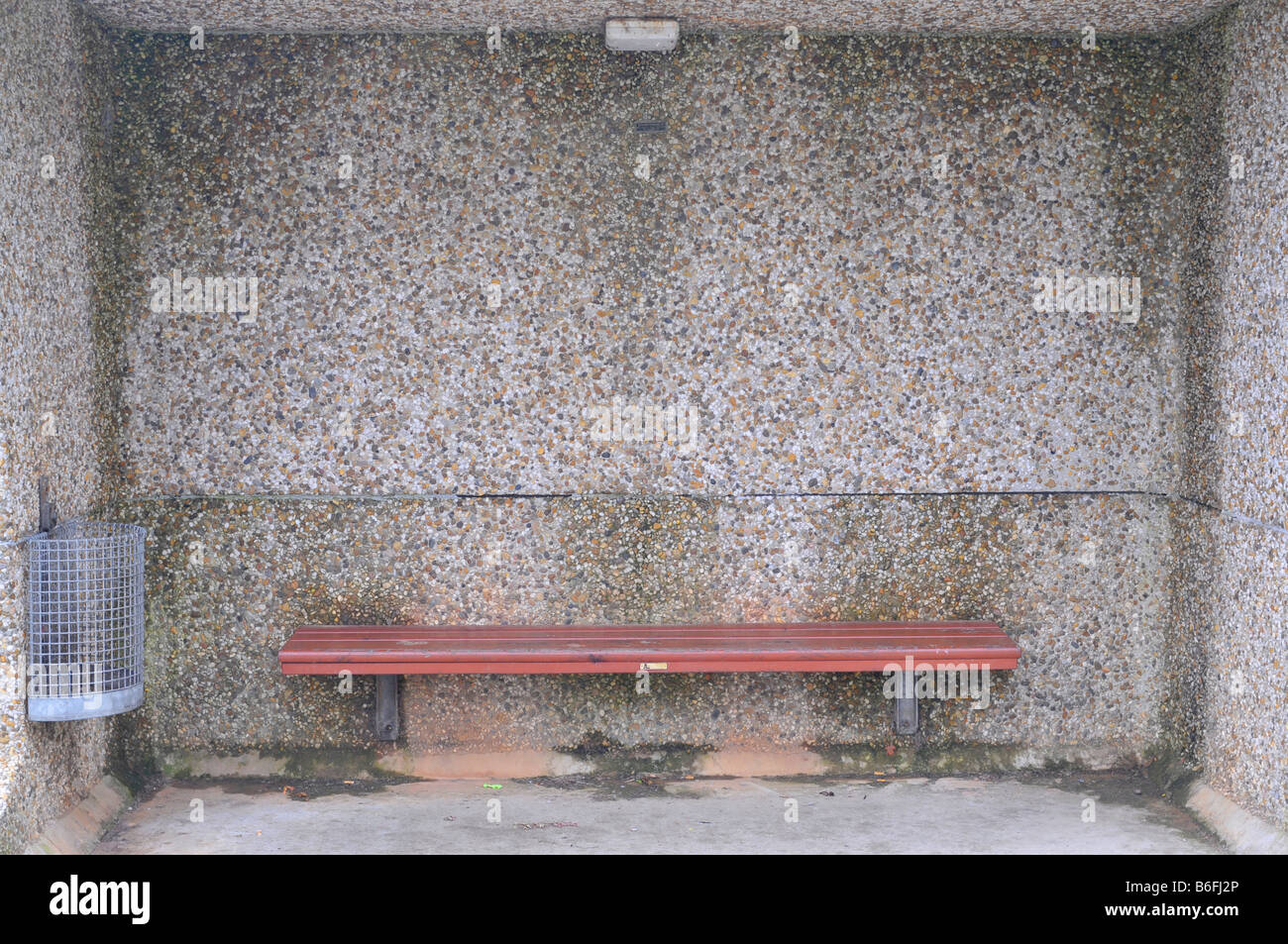 Bus stop from seventies, with bench and garbage can Stock Photo