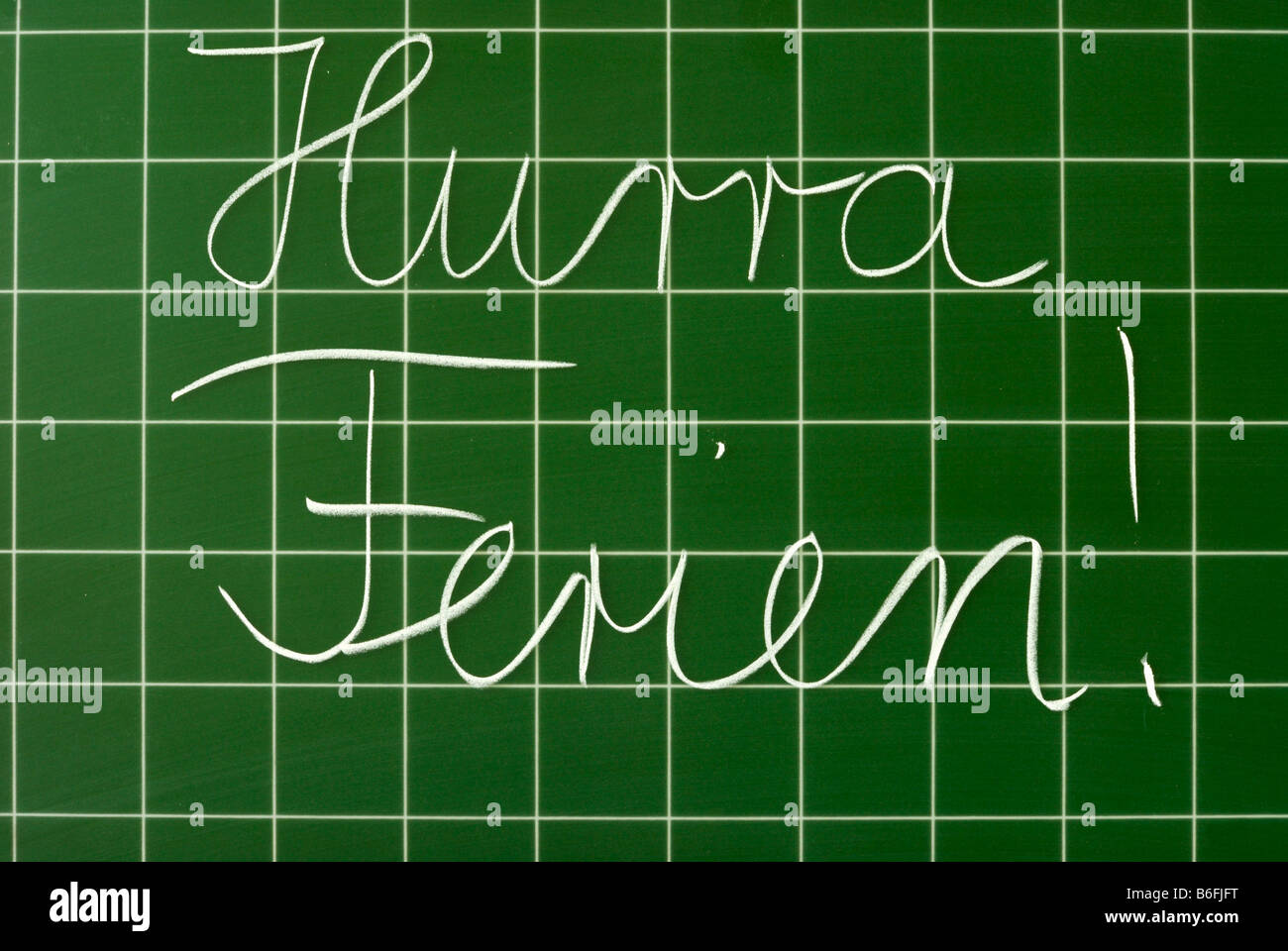 German handwritten text on a chalkboard with grid, Hurra Ferien!, Hooray for holidays! Stock Photo