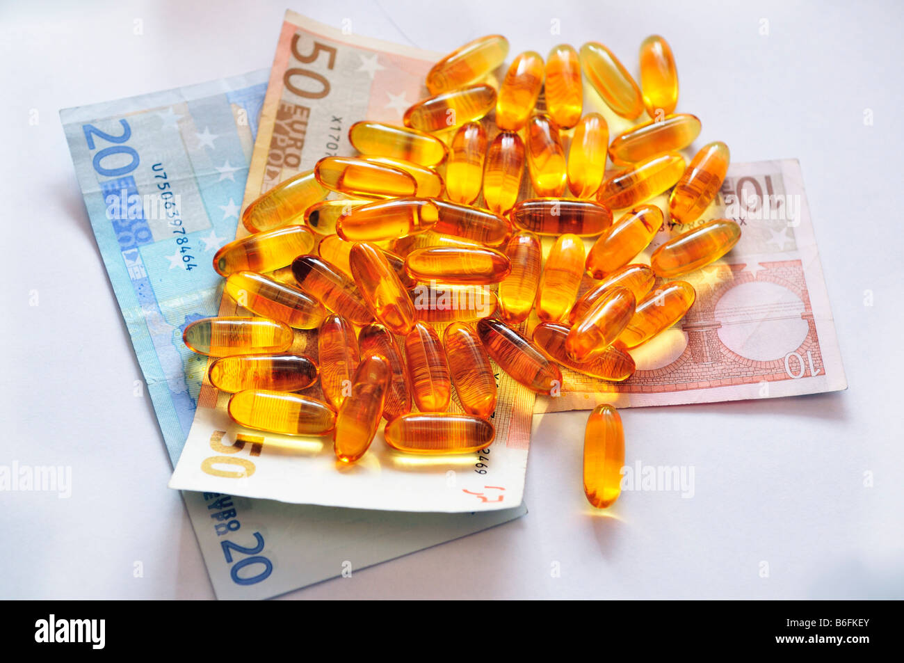 Medicine pills, capsules on bank notes Stock Photo